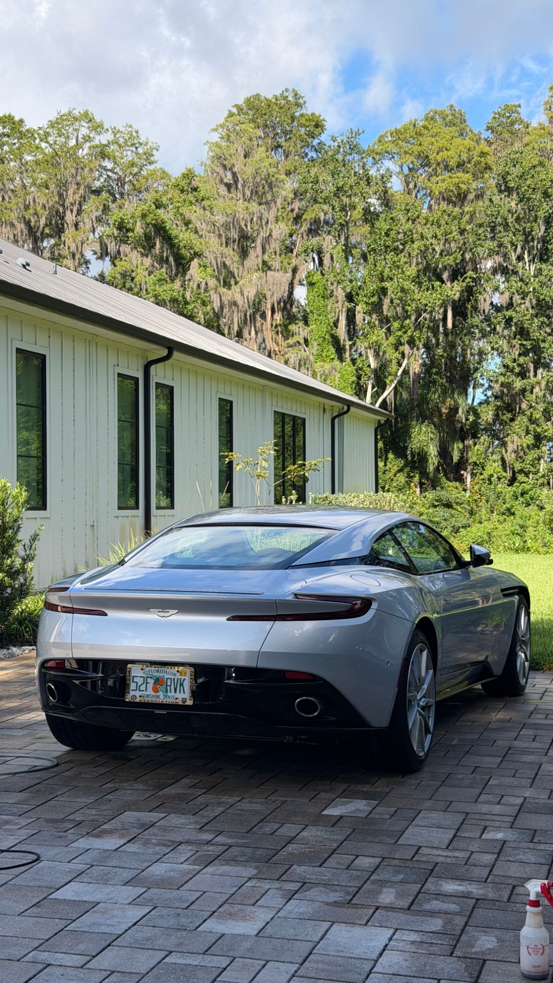 Silver Aston Martin DB11 — rear view after detailing